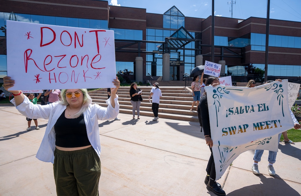 (Rick Egan | The Salt Lake Tribune)  Abigail Gutierrez holds a sign supporting the swap meet, before the West Valley City Planning Commission meeting, on Wednesday, June 12, 2024.