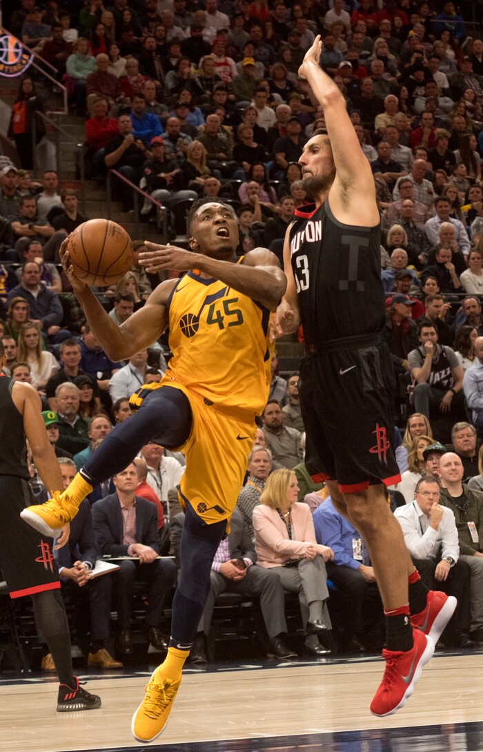 (Rick Egan  |  The Salt Lake Tribune)  Utah Jazz guard Donovan Mitchell (45) takes the ball inside as Houston Rockets forward Ryan Anderson (33) in NBA action, Utah Jazz vs Houston Rockets in Salt Lake City, Thursday, December 7, 2017.


