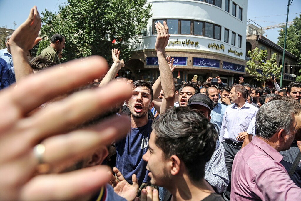 (Iranian Labor News Agency via AP) A group of protesters chant slogans at the main gate of old grand bazaar in Tehran, Iran, Monday, June 25, 2018. Protesters in the Iranian capital swarmed its historic Grand Bazaar on Monday, news agencies reported, and forced shopkeepers to close their stalls in apparent anger over the Islamic Republic's troubled economy, months after similar demonstrations rocked the country.