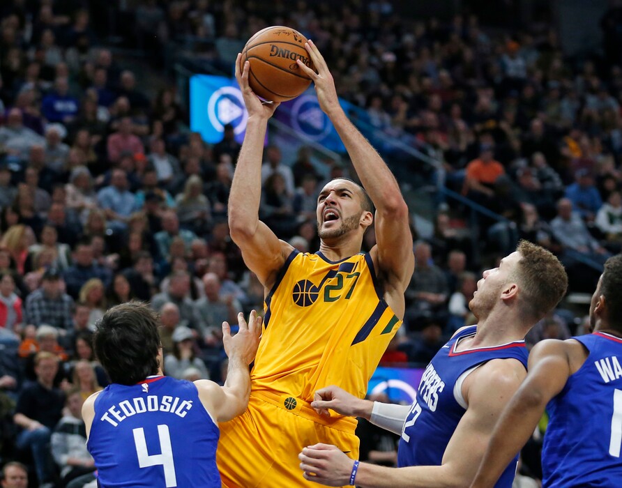 Utah Jazz center Rudy Gobert (27) goes to the basket as Los Angeles Clippers' Milos Teodosic (4) and Blake Griffin, right, defend during the second half of an NBA basketball game Saturday, Jan. 20, 2018, in Salt Lake City. (AP Photo/Rick Bowmer)