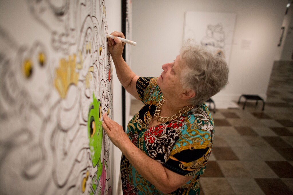 (Evan Cobb | The Daily Herald | The Associated Press) Georgia Roskelly, from American Fork, works on filling in a comic panel at the "Heroes and Villains" show at the Woodbury Art Museum on Tuesday, July 31, 2018, in Orem, Utah. "This appeals to all ages," Roskelly said about the show.