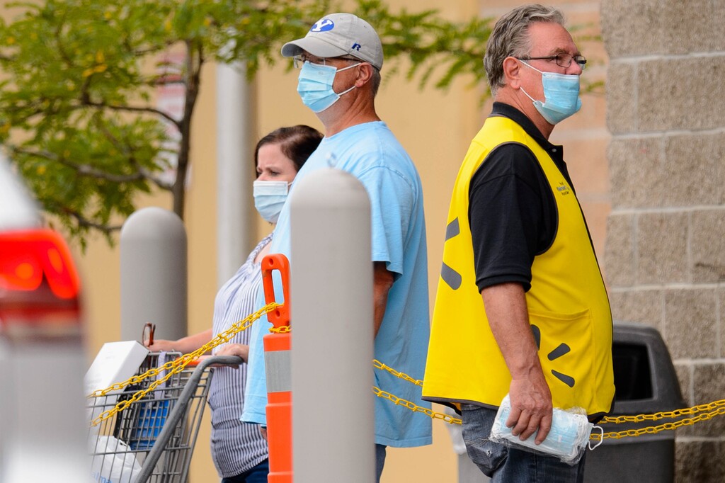 (Trent Nelson | The Salt Lake Tribune) A greeter at Walmart in American Fork hands out masks on Friday, Sept. 18, 2020. The positivity rate for COVID-19 tests in Utah County has reached 21%, meaning one out of every five people tested for the coronavirus comes back with a positive result.