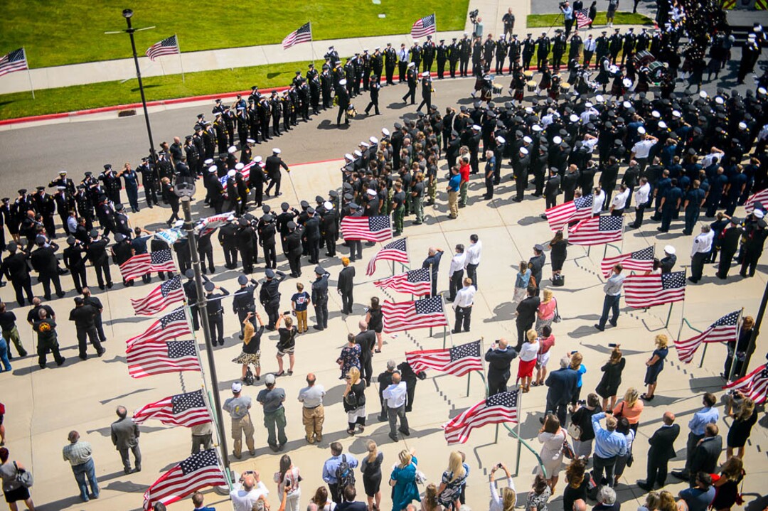 (Trent Nelson | The Salt Lake Tribune)  Funeral services for Battalion Chief Matthew Burchett at the Maverik Center in West Valley City, Monday Aug. 20, 2018.