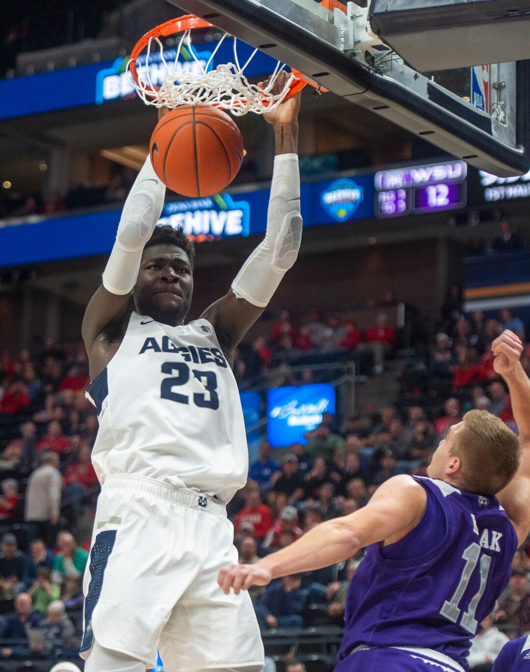(Rick Egan  |  The Salt Lake Tribune)   Utah State Aggies center Neemias Queta (23) dunks the ball, as Weber State Wildcats forward Michal Kozak (11) defends, in basketball action in the Beehive Classic, between against the Utah State Aggies and Weber State Wildcats, a the Vivint Smart Home Arena, Saturday December 8, 2018. 