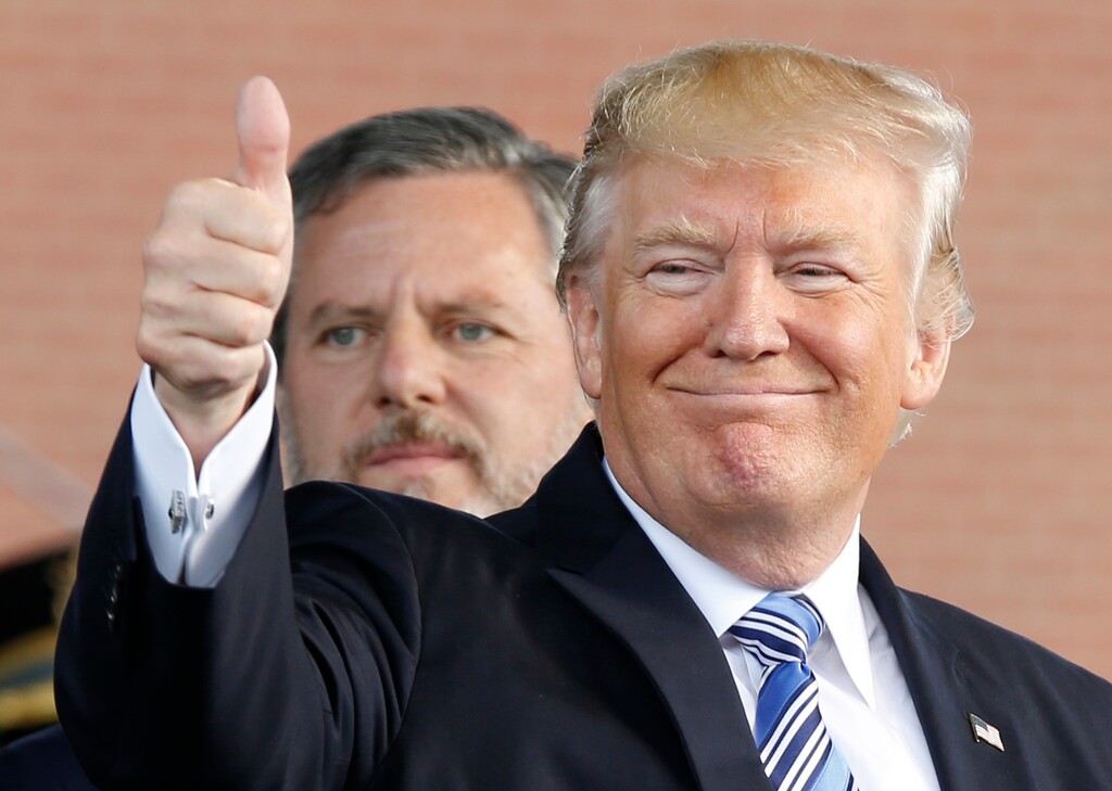 (Steve Helber | AP File Photo) In this May 13, 2017 file photo, President Donald Trump, right, gives a thumbs up as Liberty University president, Jerry Falwell Jr., left, watches during of commencement ceremonies at the school in Lynchburg, Va.