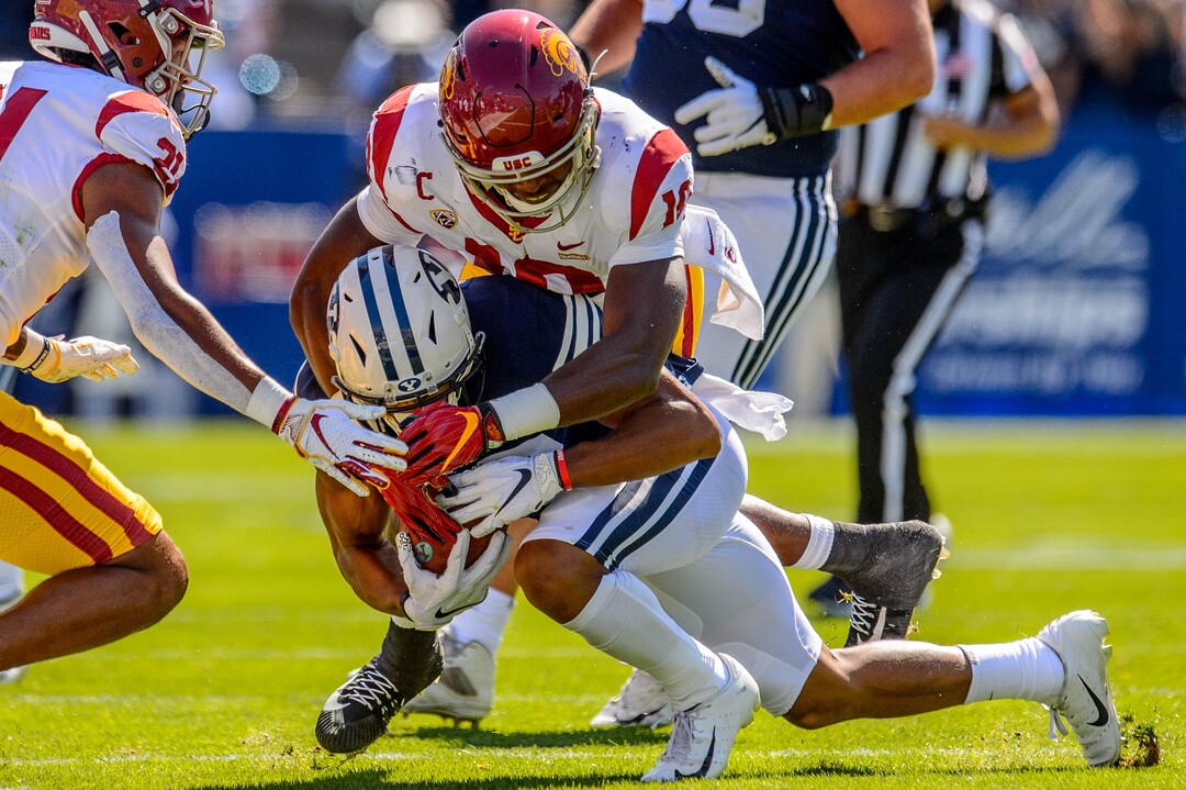 (Trent Nelson  |  The Salt Lake Tribune)  USC Trojans linebacker John Houston Jr. (10) tackles Brigham Young Cougars wide receiver Micah Simon (13) as BYU hosts USC, NCAA football in Provo on Saturday Sept. 14, 2019.