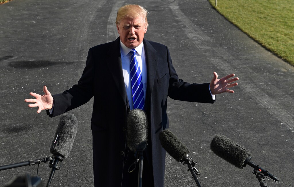 (Susan Walsh | The Associated Press) President Donald Trump talks with reporters as he departs from the South Lawn of the White House via Marine One in Washington, Saturday, Dec. 16, 2017, to spend the weekend at Camp David in Maryland.