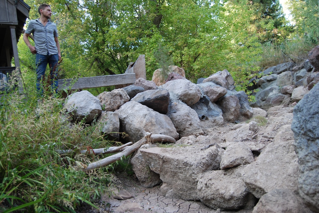 (Brian Maffly, The Salt Lake Tribune)
Sam Plumb inspects the dry creek bed on his family’s property in Emigration Canyon. The creek through much of the canyon has been completely dewatered for the past two months, a sign of Utah’s worsening drought and possibly excessive groundwater pumping to feed hundreds of homes in the canyon east of Salt Lake City.