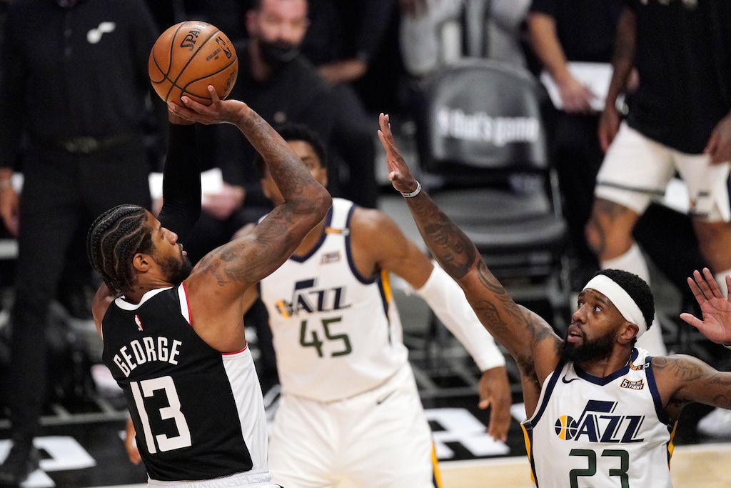 Los Angeles Clippers guard Paul George, left, shoots as Utah Jazz forward Royce O'Neale defends during the second half of Game 3 of a second-round NBA basketball playoff series Saturday, June 12, 2021, in Los Angeles. (AP Photo/Mark J. Terrill)