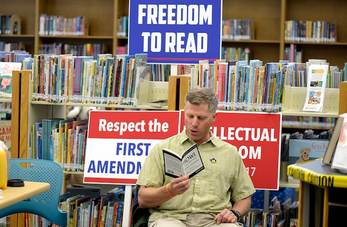 (Scott Sommerdorf   |  The Salt Lake Tribune)   
Carvel Harward reads a copy of Allen Ginsberg's "Howl" at the Smith Branch of the County Library. The public was invited to bring their favorite banned book to the Smith branch and participate in a Facebook live event where they would all read from their banned books, simultaneously, for approximately three minutes in celebration of our intellectual freedom, Sunday, September 24, 2017.