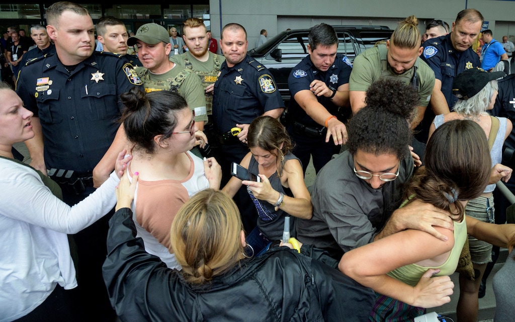 Protestors clash with law enforcement outside the Ernest Morial Convention Center in New Orleans, Monday, June 18, 2018, after U.S. Attorney General Jeff Sessions spoke at the National Sheriffs' Association opening session. Protestors were against the detainment and separation of immigrant children from their parents on the U.S. border. The sheriffs' association is a trade organization of law enforcement professionals representing more than 3,000 elected sheriffs across the nation.  (Matthew Hinton/The Advocate via AP)