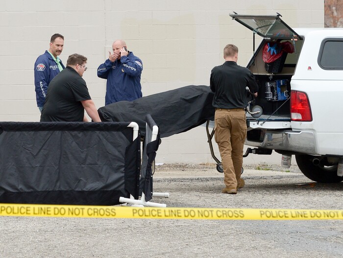 (Leah Hogsten  |  The Salt Lake Tribune)  West Valley City Police officers work the scene where a body was recovered from a storm culvert on the grounds of the the vacant Kmart building at 4100 South and 1770 West in West Valley City, Friday, April 6, 2018. 