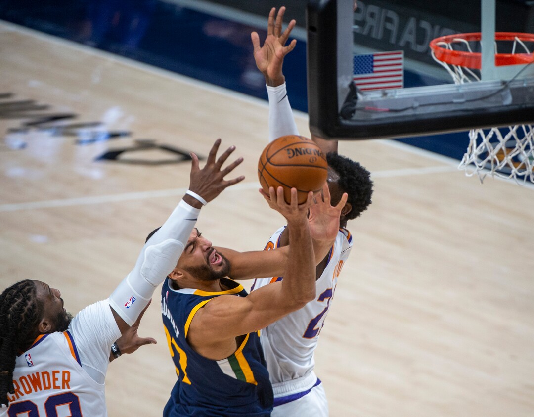 (Rick Egan | The Salt Lake Tribune) Utah Jazz center Rudy Gobert (27) gets past Phoenix Suns forward Jae Crowder (99) as he goes to the hoop, in NBA action between the Utah Jazz and the Phoenix Suns, on Thursday, Dec. 31, 2020.