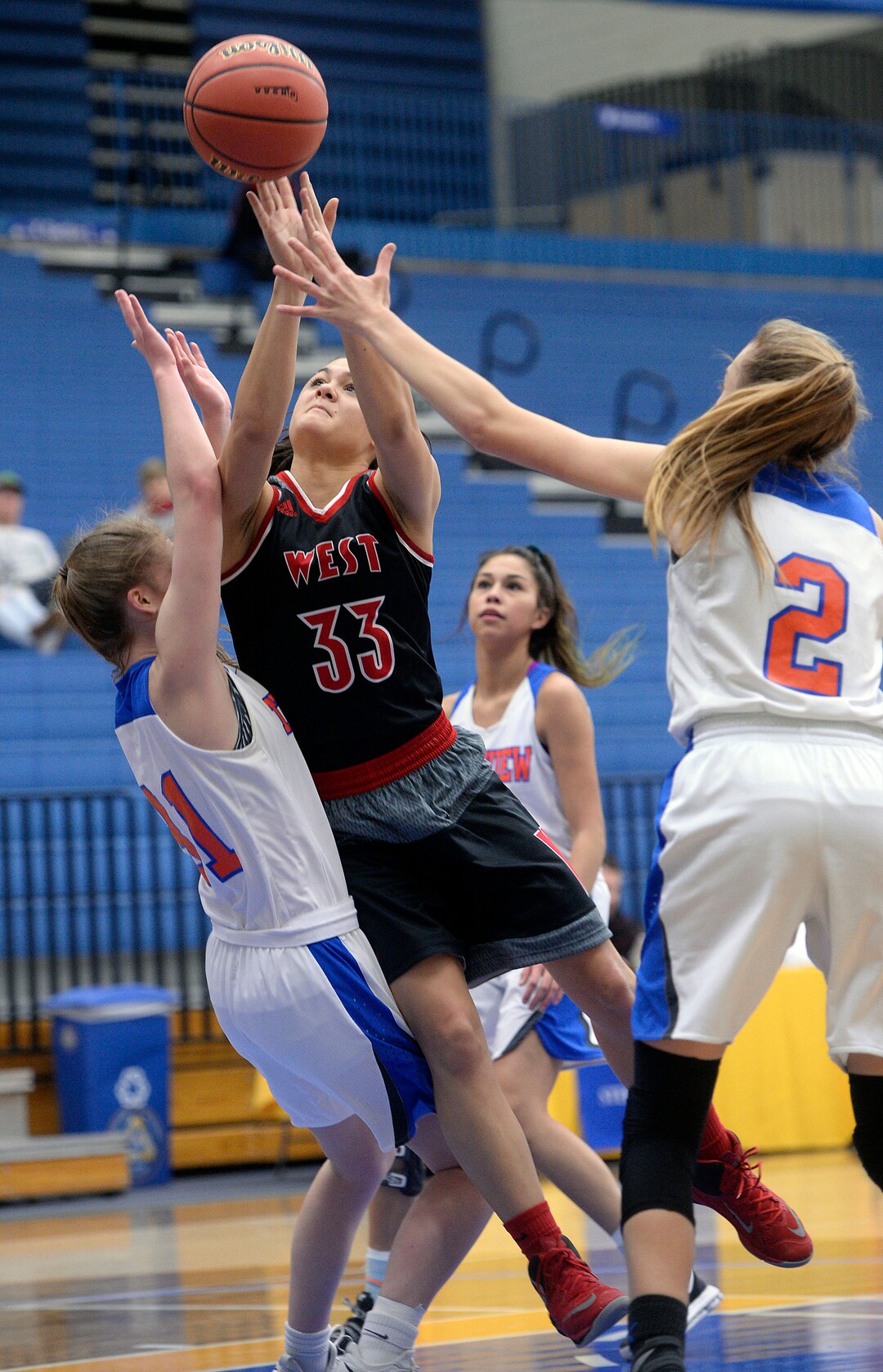 (Al Hartmann  |  The Salt Lake Tribune) 	West High School's Brianna White tries to shoot past Timpview's Arden Jansen, left and Madelyn Boulton in the Class 5 girls' basketball playoff game Monday Feb. 19 2018