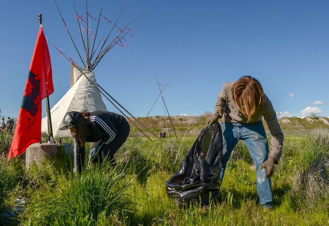 Leah Hogsten  |  The Salt Lake Tribune  l-r Mandy Rough and Darin Mann pick up trash at a dump site on 7200 West and I-80.  The "Stop the Polluting Port" community coalition staged a May Day celebration, calling for respect and awareness of the water, earth and air regarding the 20,000 acres west of Salt Lake City where the inland port industrial site has been proposed.