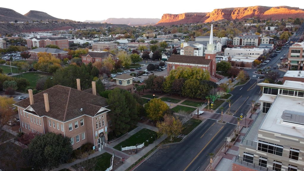(Jud Burkett | Special to The Tribune) Historic buildings including the Dixie Academy Building, lower right, and St. George Tabernacle stand in downtown St. George as the sun sets on the red hills north of town, Monday, Dec. 1, 2025.