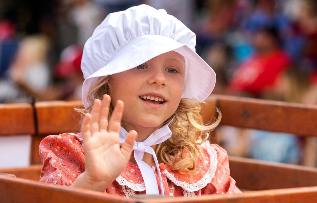 (Rick Egan | The Salt Lake Tribune) Juniper Kirkham, 8 rides in a handcart, in the Days of '47 Parade, in Salt Lake City, on Friday, July 23, 2021.