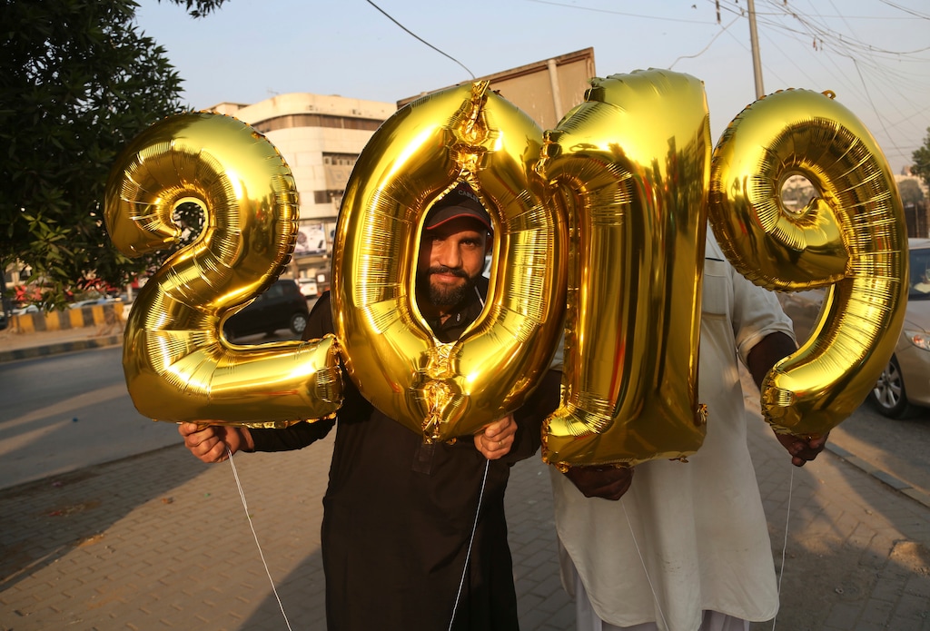 (Shakil Adil | The Associated Press) Pakistani vendors sell balloons on  New Year's Eve, in Karachi, Pakistan, Monday, Dec. 31, 2018.