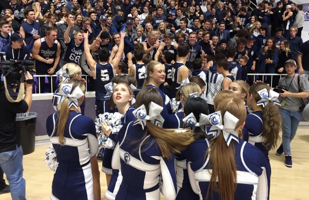 Tribune photo by Tom Wharton | Victorious Corner Canyon players and fans celebrate the Chargers victory over Jordan Saturday night in the state 5A boys basketball championship game.