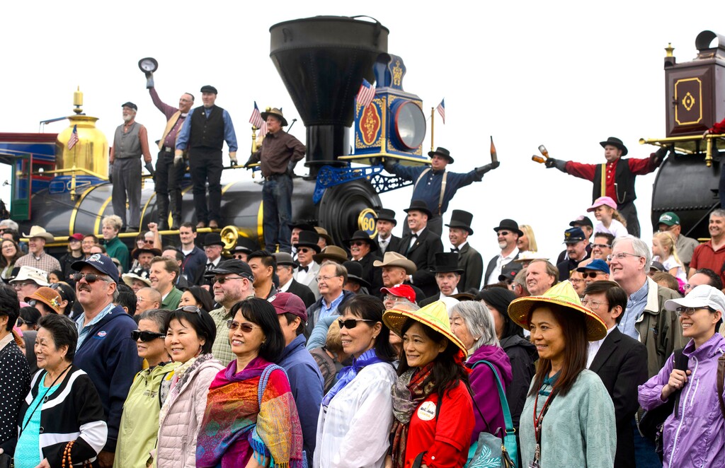 (Steve Griffin  |  The Salt Lake Tribune)  Members of the Chinese Railroad Workers Descendants Association are photographed  with the Central Pacific Jupiter and the Union Pacific No. 119 during the reenactment of the historic campaign photo during ceremony for the completion of the Transcontinental Railroad at Promontory Summit in northern Utah Thursday May 10, 2018. 