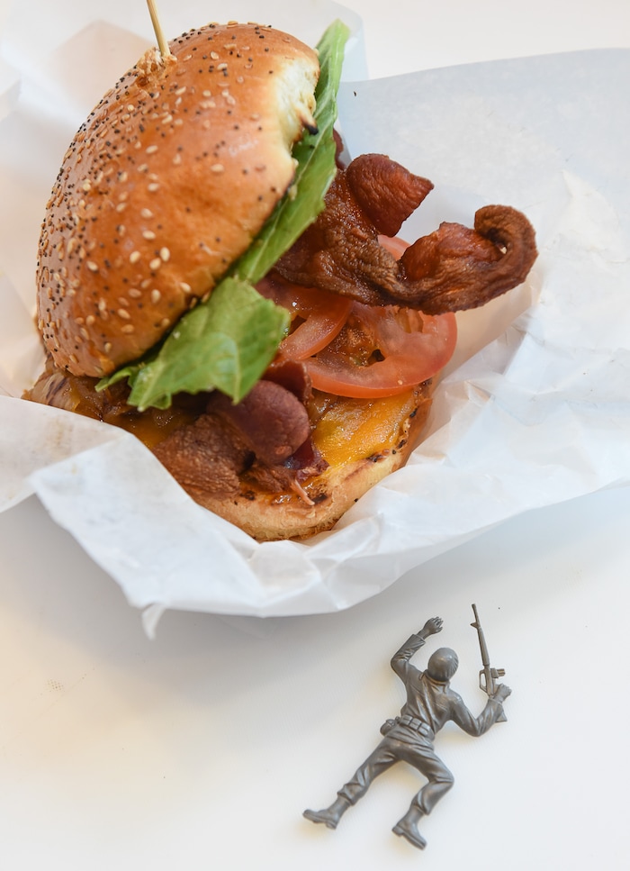 (Francisco Kjolseth | The Salt Lake Tribune) Whiskey-Tango-Foxtrot is loaded, with 1/4 lb hamburger, cheddar cheese, Jack Daniel's whiskey caramalized onions, bacon, lettuce, tomato and private sauce. Special Courses, a military-themed restaurant in the dining terrace at The Shops at South Town in Sandy, specializes in burgers and fries. Staff Sgt. James Veylupek, the owner, got help launching the eatery after winning Taste for the Space in May 2017.