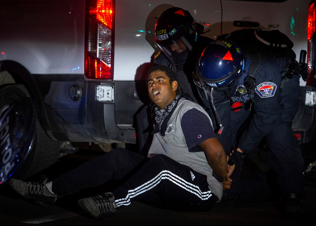 (Rick Egan  |  The Salt Lake Tribune) Mani Hill is arrested by police at 1300 East and 200 South, near the University of Utah where Vice President Mike Pence is debating Sen. Kamala Harris on Wednesday, Oct. 7, 2020.