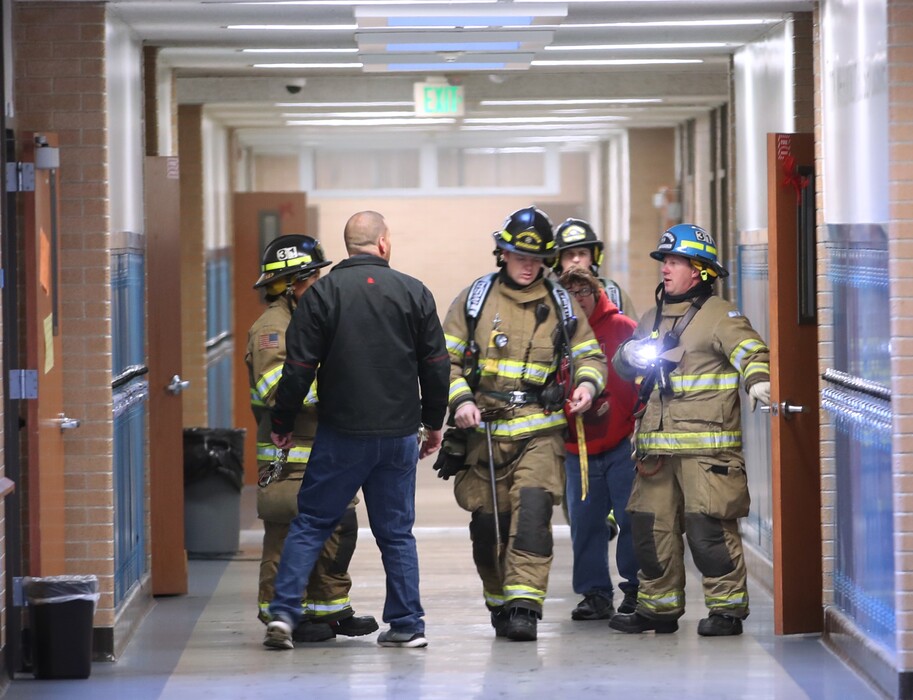 (George Frey | Special to The Tribune) Sandy firemen check classrooms after an early morning fire at Union Middle School in Sandy, Oct. 24, 2019.
