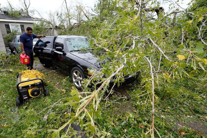 Reginald Duhon prepares to work at his home on Thursday, Aug. 27, 2020, in Lake Charles, La., after Hurricane Laura moved through the state. (AP Photo/Gerald Herbert)