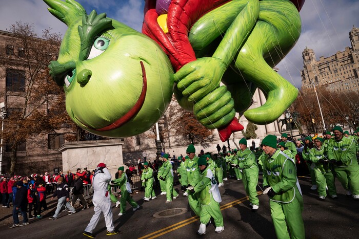(Mark Lennihan | AP) Balloon handlers hold Dr. Seuss' The Grinch close to the ground as strong winds affect the Macy's Thanksgiving Day Parade, Thursday, Nov. 28, 2019, in New York.