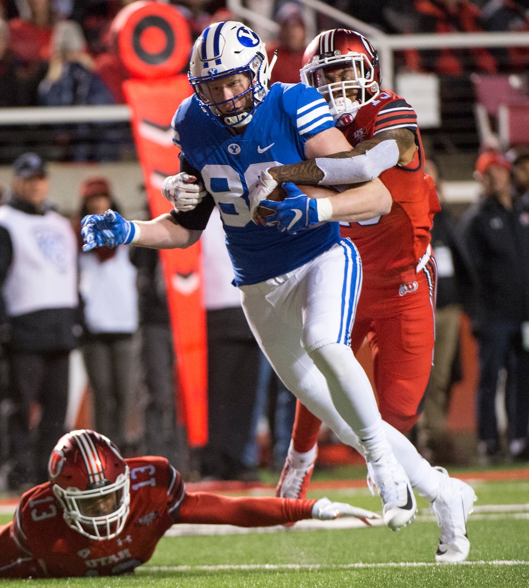 (Rick Egan  |  The Salt Lake Tribune)      Brigham Young Cougars tight end Matt Bushman (89) gets past Utah Utes defensive back Marquise Blair (13) and Utah Utes defensive back Corrion Ballard (15) to score a touchdown for the Cougars, in football action between the Brigham Young Cougars and the Utah Utes, at Rice-Eccles Stadium, Saturday, November 24, 2018.
