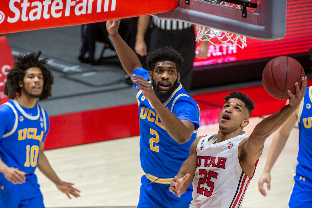 (Rick Egan | The Salt Lake Tribune) Utah Utes guard Alfonso Plummer (25) takes the ball to the hoop, as UCLA Bruins forward Cody Riley (2) defends, in PAC-12 basketball action at the Jon M. Huntsman Center, on Thursday, Feb. 25, 2021.