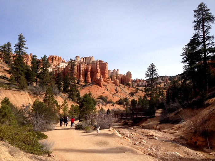 Erin Alberty  |  The Salt Lake TribuneHikers approach a bridge as hoodoos stand sentry over the trail to Mossy Cave on March 31, 2016 in Bryce Canyon National Park.