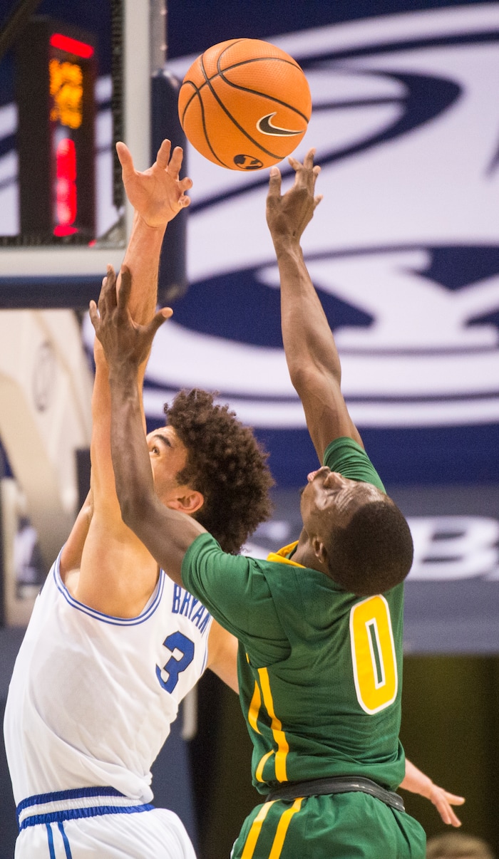 (Rick Egan  |  The Salt Lake Tribune)  Brigham Young Cougars guard Elijah Bryant (3) defends as San Francisco Dons guard Souley Boum (0) shoots, in basketball action at the Marriott Center, Saturday, February 10, 2018.