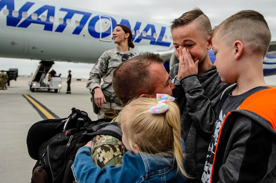 (Trent Nelson  |  The Salt Lake Tribune)  Sergeant First Class Thomas Crocker is welcomed home by his children Anabelle, Kaidin, and Bryson as almost 100 Soldiers from Utah Army National Guard’s Echo Battery, 1st Battalion, 145th Field Artillery, “Big Red” return after a 10-month Middle East deployment, on Tuesday April 9, 2019 at Wright Air Base in Salt Lake City.
