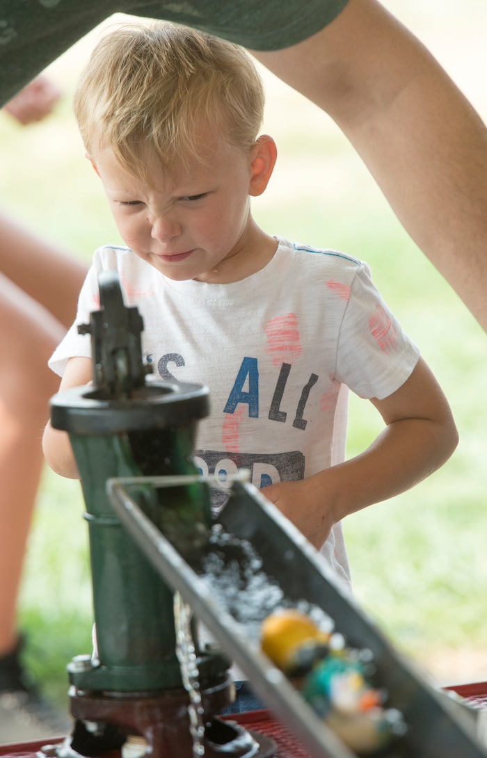 (Rick Egan  |  The Salt Lake Tribune)    Logan Harry, 4, from Kaysville, sends a rubber duck down a slide by pumping a water pump, at the Davis County Fair in Farmington, Saturday, Aug. 18, 2018.