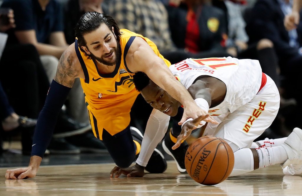 Utah Jazz's Ricky Rubio, of Spain, left, reaches for a loose ball against Atlanta Hawks' Dennis Schroder, of Germany, in the first quarter of an NBA basketball game in Atlanta, Monday, Jan. 22, 2018. (AP Photo/David Goldman)