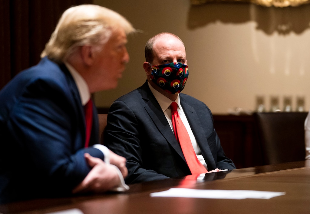 (Doug Mills | The New York Times)
President Donald Trump during a meeting with Colorado Gov. Jared Polis, a Democrat, right, at the White House in Washington, May 13, 2020. "Refusing to cover one’s face is reckless, selfish behavior that imperils the economy and can kill or endanger innocent people," writes Nicholas Kristof.
