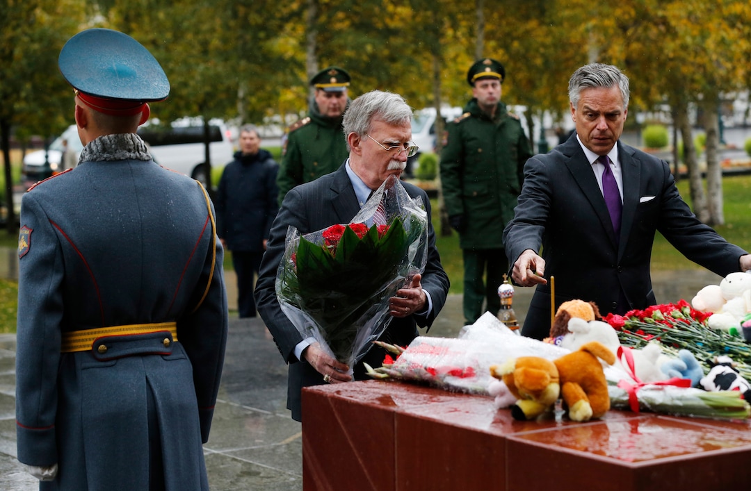 (Alexander Zemlianichenko  |  AP Photo) U.S. National Security Adviser John Bolton, center, and U.S. Ambassador to Russia Jon Huntsman, right, attend a flower-laying ceremony at a memorial in memory of the victims of last week's attack on a vocational college in Kerch, on the Crimean peninsula, in the Alexander Garden near the Kremlin, in Moscow, Russia, Tuesday, Oct. 23, 2018. U.S. President Donald Trump's national security adviser Bolton struck a conciliatory note Tuesday in talks in Moscow, just days after Trump vowed to pull out of a key arms control treaty with Russia. 