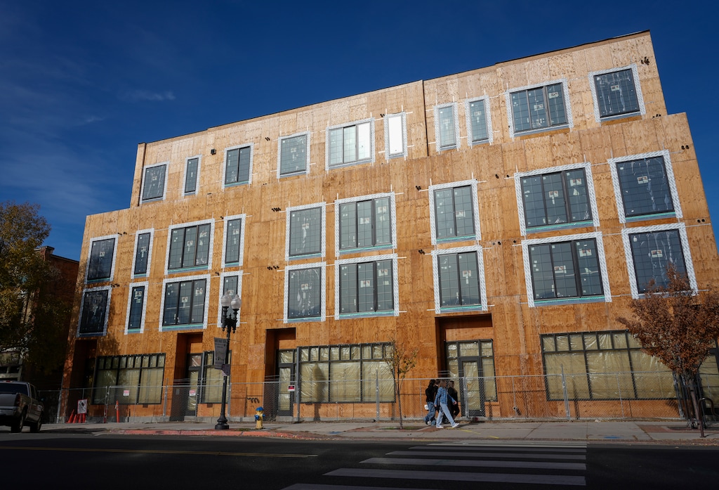 (Bethany Baker  |  The Salt Lake Tribune) People walk past the Union Walk building, where construction was halted in March 2023, on 25th Street in downtown Ogden on Saturday, Nov. 11, 2023.