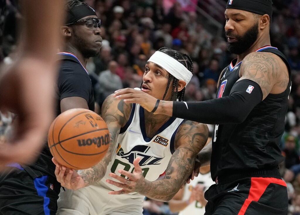 (Francisco Kjolseth | The Salt Lake Tribune) Utah Jazz guard Jordan Clarkson (00) gets sandwiched by the defense of Reggie Jackson, left, and Marcus Morris in a game between the Utah Jazz and the LA Clippers on Wednesday, Dec. 15, 2021 at Vivint Smart Home Arena in Salt Lake City. Morris said after the game that none of the Jazz players other than Rudy Gobert can play any defense.