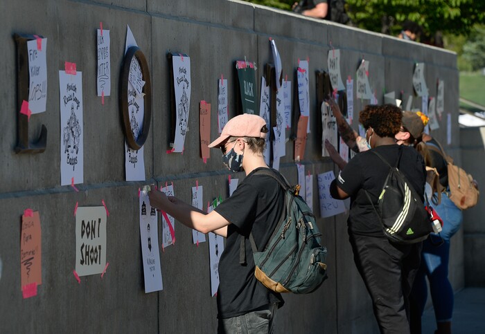 (Francisco Kjolseth  |  The Salt Lake Tribune) Protesters tape signs to the facade outside the Capitol building as part of rally against police brutality on Friday, June 26, 2020. Demonstrators removed the signs before leaving.