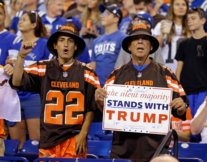 Cleveland Browns fans hold a sign following the national anthem before an NFL football game between the Indianapolis Colts and the Cleveland Browns in Indianapolis, Sunday, Sept. 24, 2017. (AP Photo/Michael Conroy)