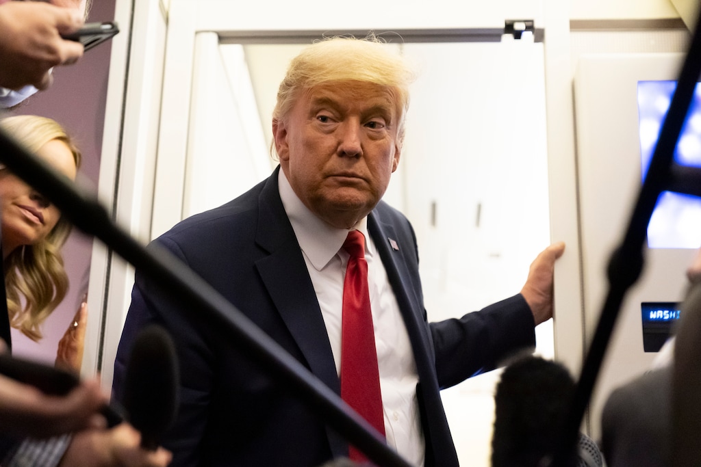 (Alex Brandon | AP photo)
President Donald Trump leans in to hear a question as he speaks with reporters while in flight on Air Force One after a campaign rally at Tucson International Airport, in Tucson, Ariz., Monday, Oct. 19, 2020, while en route to Andrews Air Force Base, Md.