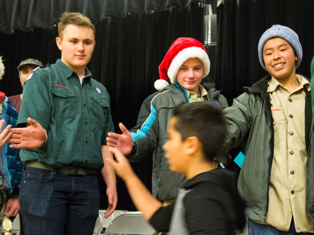 (Rick Egan  |  The Salt Lake Tribune)   Boy Scouts, Jonah Berthold, Spencer Boyer  and Gonzolo Perez, greet  students at Centennial Elementary School, in Roosevelt, Utah. The scouts helped gather school supplies and gifts for volunteer pilots from the Utah Wing of Angel Flight West, to bring to the students in Roosevelt on their annual Santa Flight. Friday, December 8, 2017.