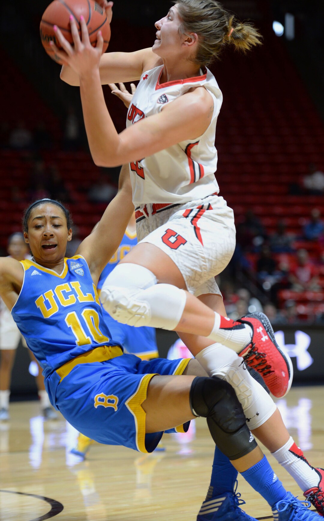 Steve Griffin  |  The Salt Lake TribuneUtah Utes forward Emily Potter (12) crashes into UCLA's Kacy Swain drawing a charging foul during basketball game at the Huntsman Center in Salt Lake City, Sunday, January 31, 2016. 