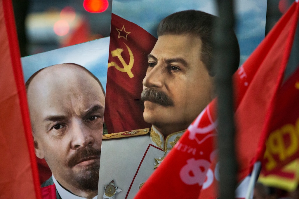 Communist party supporters carry portraits of Soviet founder Vladimir Lenin, left, and Soviet dictator Josef Stalin during a demonstration marking the 100th anniversary of the 1917 Bolshevik revolution in Moscow, Russia, Tuesday, Nov. 7, 2017. Thousands of Communist demonstrators marked the centennial of the 1917 Bolshevik revolution Tuesday by marching across downtown Moscow. (AP Photo/Alexander Zemlianichenko)