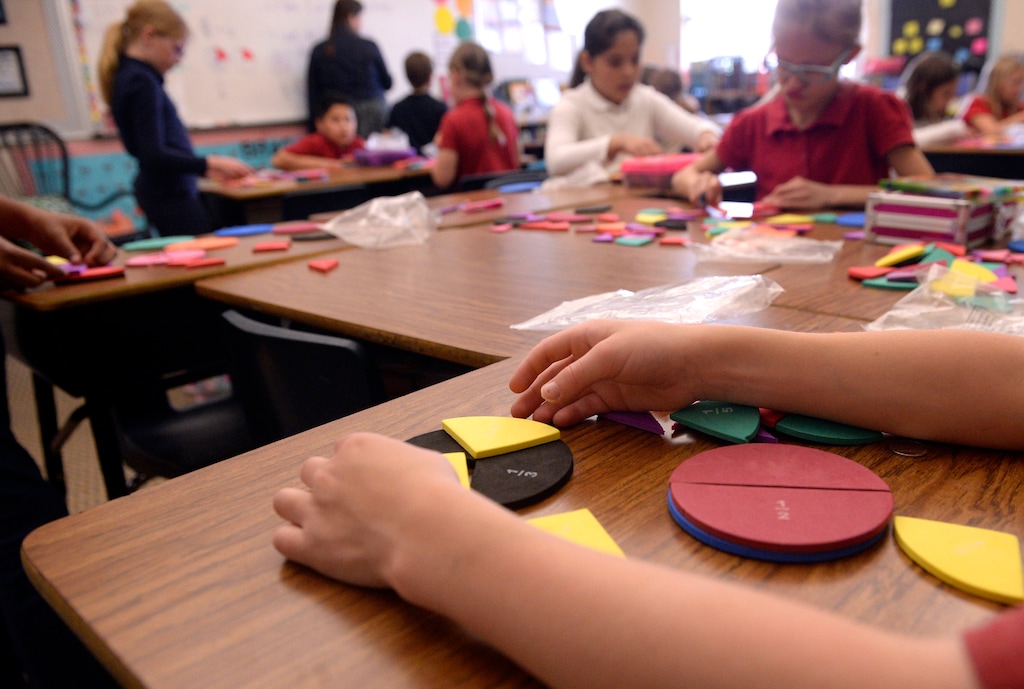 (Al Hartmann | The Salt Lake Tribune) Third graders at Wasatch Peak Academy in North Salt Lake use colored shapes to learn fractions in a geometry class in August 2017.