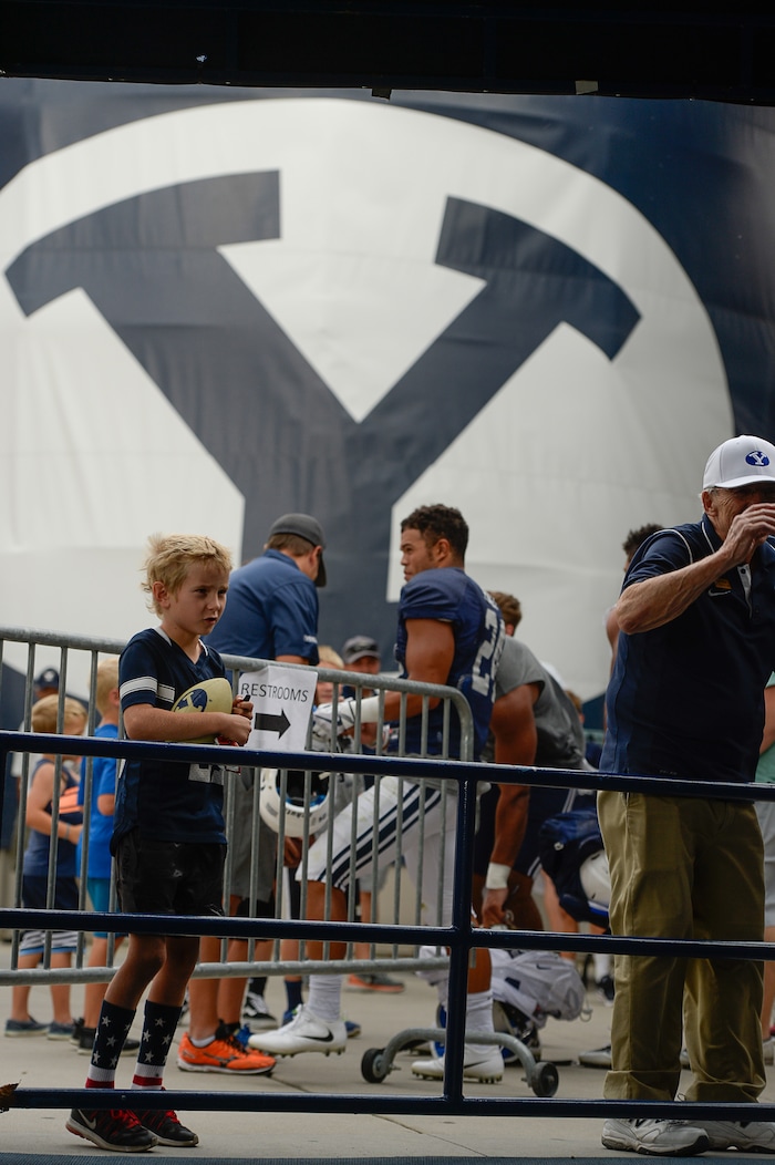 (Francisco Kjolseth  |  The Salt Lake Tribune)  Young fans hold out for autographs following a BYU scrimmage at LaVell Edwards Stadium in Provo on Thursday, Aug. 10, 2017.