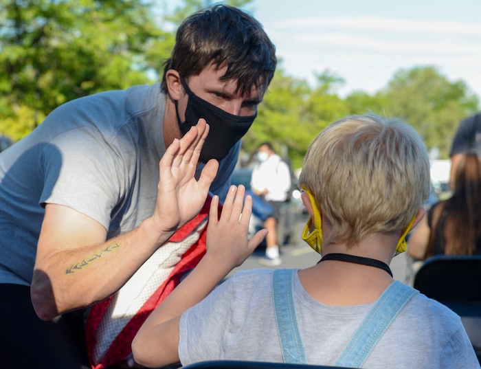 (Chris Samuels | The Salt Lake Tribune) Dustin Applegate high-fives his daughter after receiving a COVID-19 test before she leaves for Camp Hope, a camp run by the Salt Lake District Attorney’s office for kids who have been victims of violence, Monday, June 28, 2021.