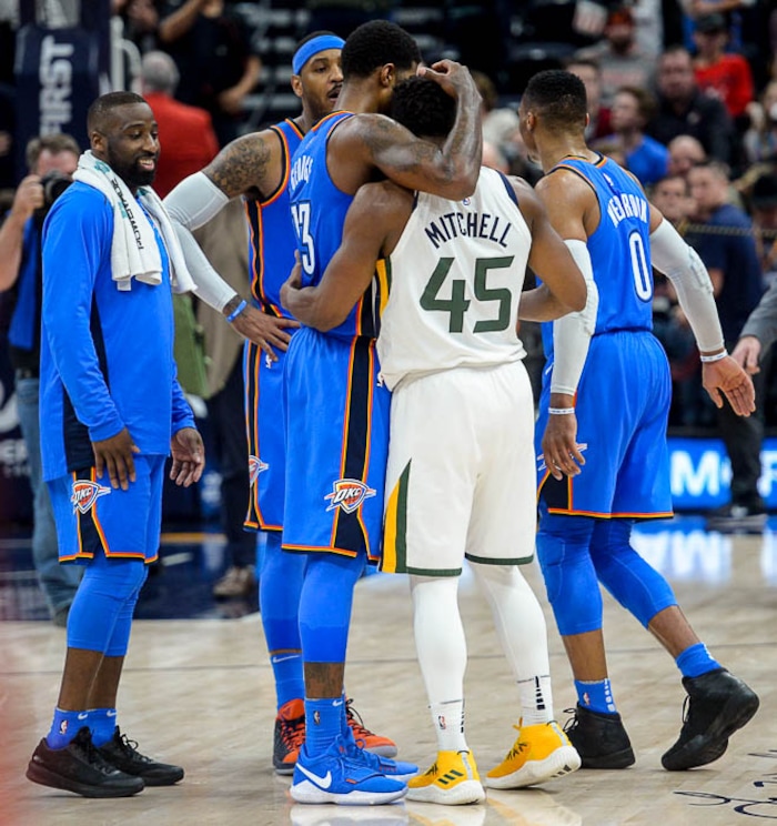 (Trent Nelson | The Salt Lake Tribune)  Oklahoma City Thunder forward Paul George (13) and Oklahoma City Thunder guard Russell Westbrook (0) embrace and talk to Utah Jazz guard Donovan Mitchell (45) after the Utah Jazz lost to the Oklahoma City Thunder, NBA basketball in Salt Lake City, Saturday December 23, 2017.